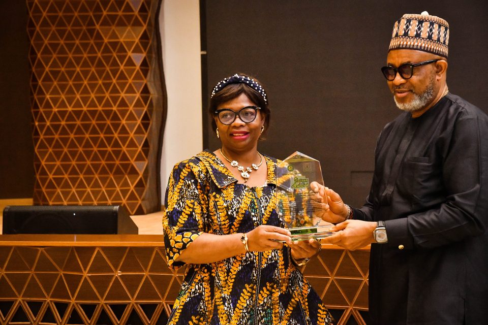 Director of Monitoring and Evaluation, NCDMB, Mr. Akintunde Adelana receiving the Board’s award from Head, Strategy, Innovation and Research, BPSR, Mrs. Mercy Okon, for emerging “a Level 5 Platinum Level organization.